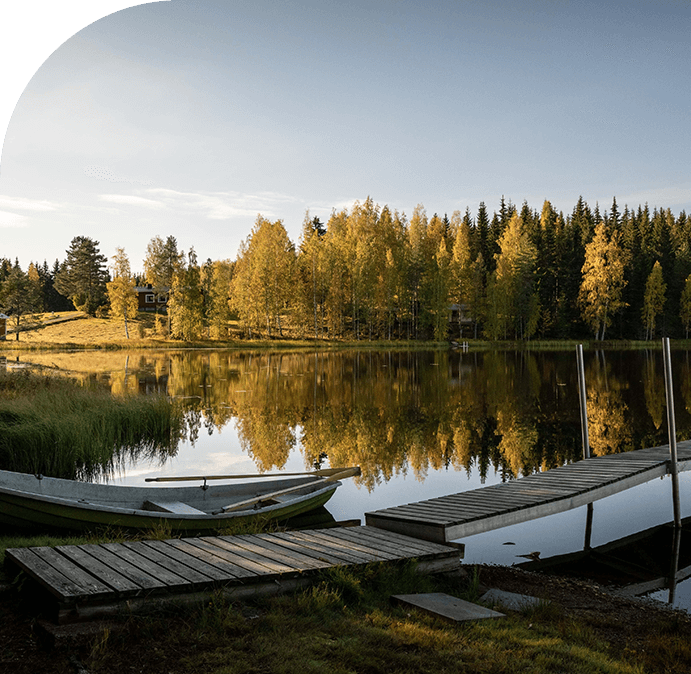 A lake with two boats on it and trees in the background.