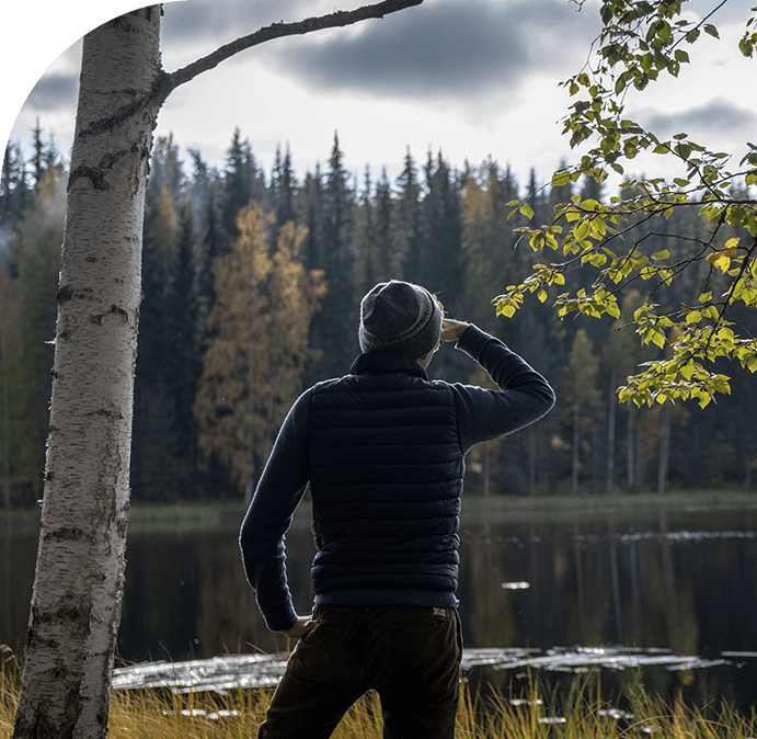 A man standing in front of a body of water.