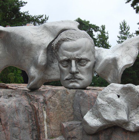 A sculpture of a man 's head and two bears.