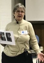 A Portrait Image of Jeanne Swope Holding Out a Paper in Hand