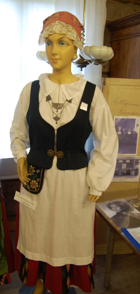 A mannequin dressed in a dress and vest.