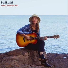DIANE JARVI Woman playing guitar by the ocean.